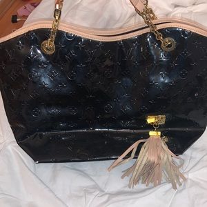 Black embossed REPLICA handbag.